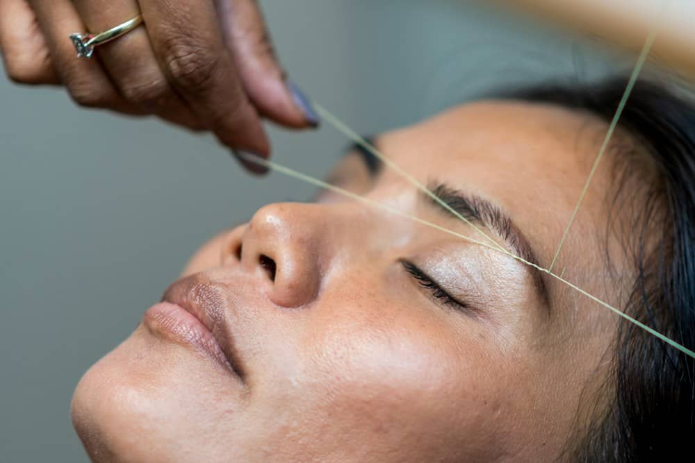 Eyebrow threading in progress